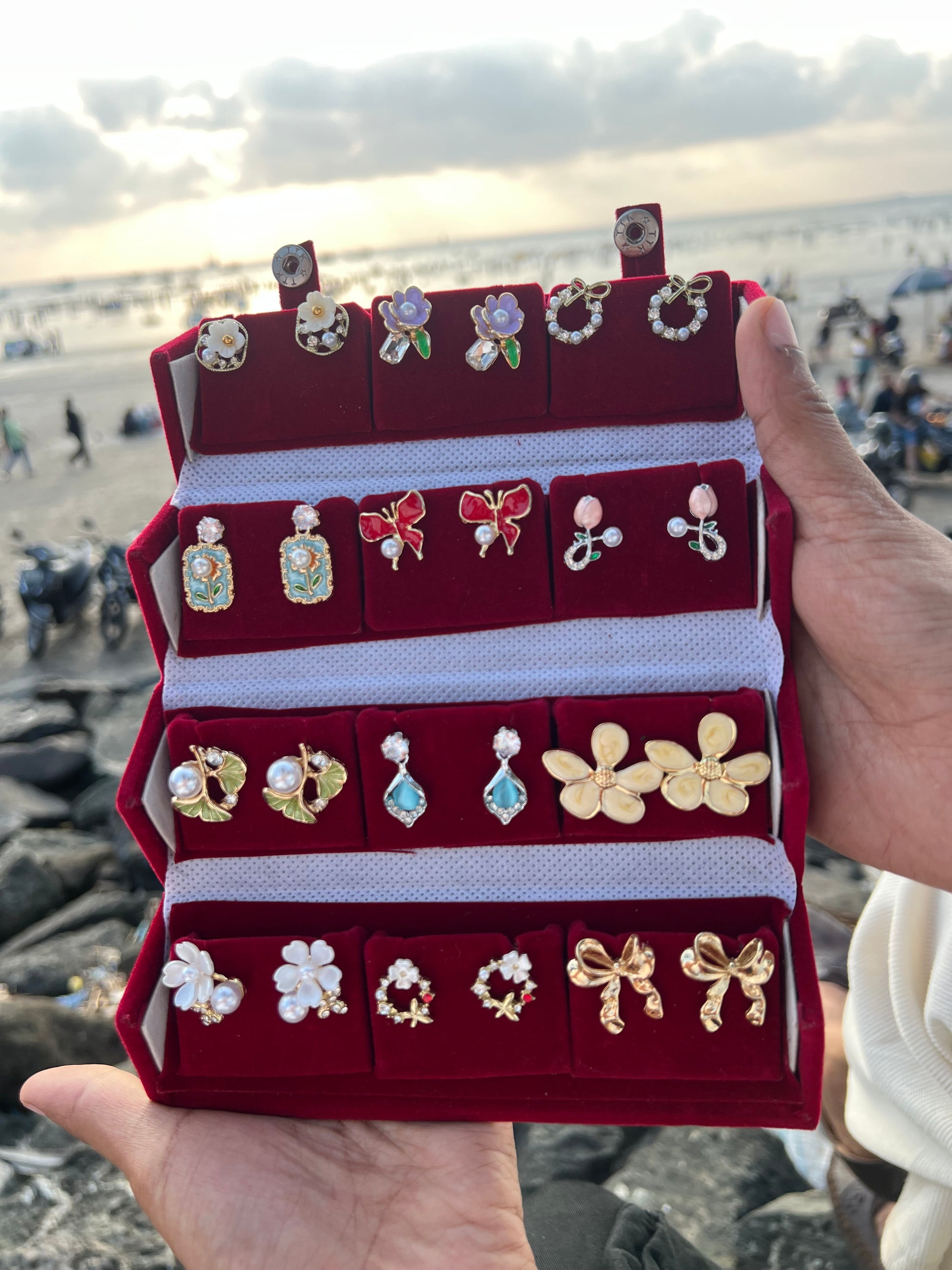 Aurelisse earring gift box open showing 12 curated anti-tarnish earring pairs inside velvet compartments
